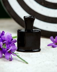 black bottle of parfum on the table